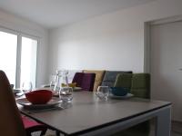 a dining room table with wine glasses and a couch at Appartement La Rochelle, 3 pièces, 4 personnes - FR-1-246-588 in La Rochelle