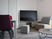 a living room with a tv and two chairs and a table at Appartement La Rochelle, 3 pièces, 4 personnes - FR-1-246-588 in La Rochelle