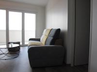 a living room with a chair and a table at Appartement La Rochelle, 3 pièces, 4 personnes - FR-1-246-588 in La Rochelle