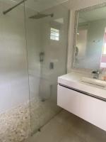 a bathroom with a shower and a sink and a mirror at Villa Anse Vinaigri - Plage à pieds in Le Gosier