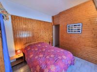 a bedroom with a bed and a wooden wall at Appartement Saint-Michel-de-Chaillol, 2 pièces, 5 personnes - FR-1-393-6 in Saint-Michel-de-Chaillol