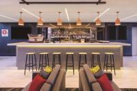 a bar in a hotel with chairs and a bar counter at Travelodge Hotel Sydney Airport in Sydney
