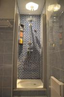 a bathroom with a shower with a glass door at Résidence Niccola in Vidauban