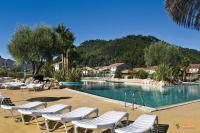 a swimming pool with lounge chairs in a resort at Résidence Niccola in Vidauban