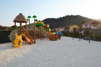 a playground with a slide in the sand at Résidence Niccola in Vidauban