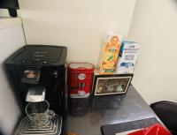 a coffee maker and other items on a counter at Appartement cosy proche Roissy CDG Astérix DisneyLand Paris in Goussainville