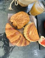 three croissants on a tray with a glass of orange juice at Appartement cosy proche Roissy CDG Astérix DisneyLand Paris in Goussainville