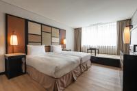 a hotel room with a large bed and a window at Beitou Sweet Me Hot Spring Resort in Taipei