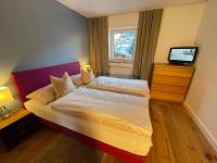 Łóżko lub łóżka w pokoju w obiekcie Chalet Augustine Hinterglemm Zentrum