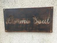 a rusty sign on the side of a wall at L&#39;Orme Seul, Maison d&#39;hôtes in Vineuil