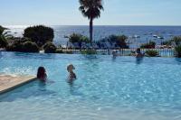 a group of people swimming in a swimming pool at Village Naturiste La Chiappa in Porto-Vecchio