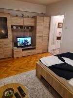 a bedroom with a bed and a flat screen tv at Kineski zid in Zenica