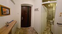 a bathroom with a wooden door in a room at Kineski zid in Zenica