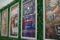 a row of signs covered in green ivy at Nomads St Kilda in Melbourne