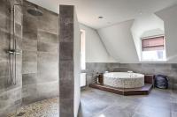 a bathroom with a tub and a shower at Villa Eltins in Bad Bentheim