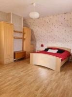 a bedroom with a bed with a red comforter at Les embruns in Petit-Berneval