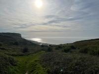 a view of the ocean from a hill with the sun at Les embruns in Petit-Berneval