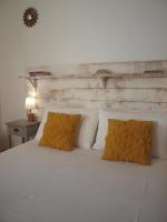 a white bed with two pillows on top of it at L&#39;Estanquet Bed and Breakfast pdj offert in Gastes