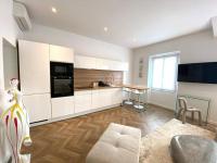 a kitchen with white cabinets and a table in a room at Superbe 2 pièces - Cannes Banane in Cannes