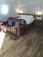 a living room with a couch and a bed at Garden Suite in Rhuddlan