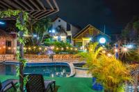 a resort with a swimming pool at night at Ecovilla Cali in Cali