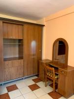 a kitchen with wooden cabinets and a table and a chair at Hotel Nalba Jupiter in Jupiter