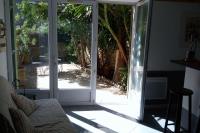 an open sliding glass door with a view of a patio at STUDIO of 24m with small patio in Avignon