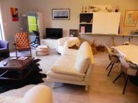 a living room with a white couch and chairs at Appartement de 3 chambres a Les Sables d&#39;Olonne a 800 m de la plage avec wifi in Les Sables-d&#39;Olonne
