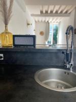 a kitchen sink with a faucet on a counter at Loft&#47;jardin et parking : Le Petit Clos Bourdet in Honfleur