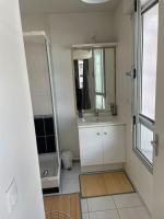 a white bathroom with a sink and a shower at Appartement en Hypercentre proche Gare Sud in Nantes