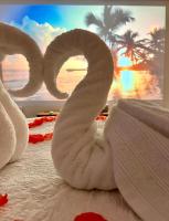 a towel swan on a bed with a view of the ocean at BIOTY CHILL &amp; SPA in Le Blanc-Mesnil