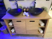 two sinks on top of a wooden vanity with towels at BIOTY CHILL &amp; SPA in Le Blanc-Mesnil