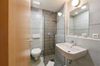a bathroom with a sink and a toilet and a shower at Hotel Korotan in Vienna