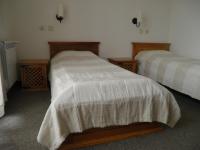 A bed or beds in a room at Pripetzite Hotel