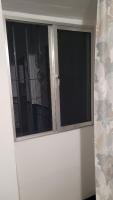a white door with a window in a room at Pensión San Benito Abad in Seville