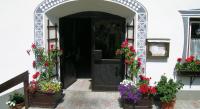 an entrance to a building with flowers in flowerpots at Apartments HAUS SCHÖN - Preise inclusive Pitztal Sommer Card in Jerzens