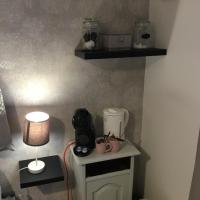 a room with a table with a coffee maker and a lamp at Mon rêve in Les Martys