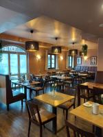 a restaurant with wooden tables and chairs at Hotel Casa Rustica - Eintrittskarten für den Europapark erhalten Sie garantiert über uns! in Rust