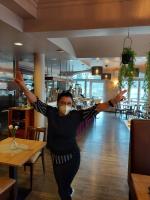 a man with a face mask dancing in a restaurant at Hotel Casa Rustica - Eintrittskarten für den Europapark erhalten Sie garantiert über uns! in Rust