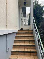 a cat sitting on the stairs of a house at Idéal 4 pièces, tout confort in Courcouronnes