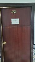 a wooden door with a sign on top of it at Pensión San Benito Abad in Seville