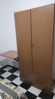 a wooden cabinet in a room with a checkered floor at Pensión San Benito Abad in Seville