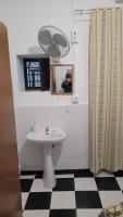 a bathroom with a sink and a shower curtain at Pensión San Benito Abad in Seville