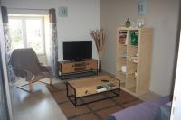 a living room with a tv and a coffee table at Gite De LA BALLADE in François