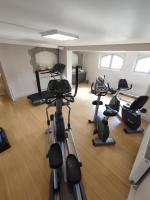 a gym with several exercise bikes in a room at Hôtel Villa Navarre in Pau
