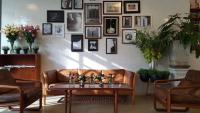 a living room with a couch and a table at Beat Hotel Bangkok in Bangkok