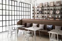 a living room with a couch and two tables at Beat Hotel Bangkok in Bangkok