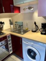 a kitchen with a washing machine and a sink at Studio quartier historique in Rouen