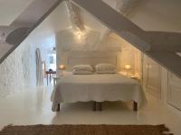 a bedroom with a white bed with two pillows at Campagne Salettes in Lorgues