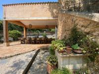a patio with a table and chairs and plants at Campagne Salettes in Lorgues